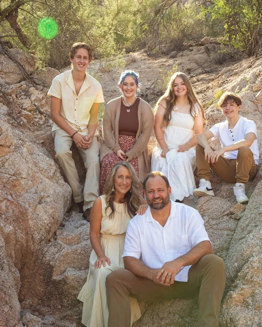 Family sitting on rocks in the desert